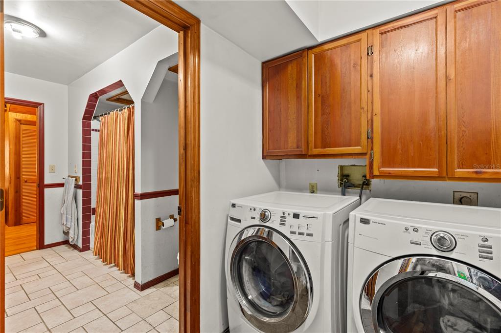 11419 Raschke Run Weeki Wachee, FL 34614 - Photo 13 of 19 a view of storage and utility room with washer and dryer