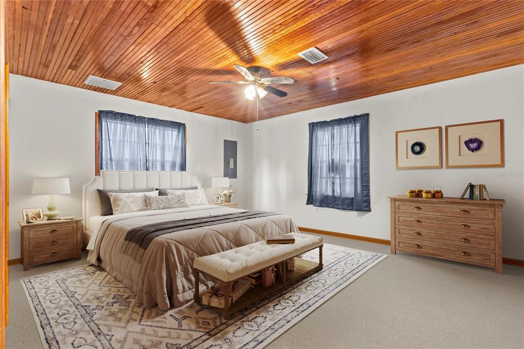 11419 Raschke Run Weeki Wachee, FL 34614 - Photo 15 of 19 a bedroom with a bed and a chandelier