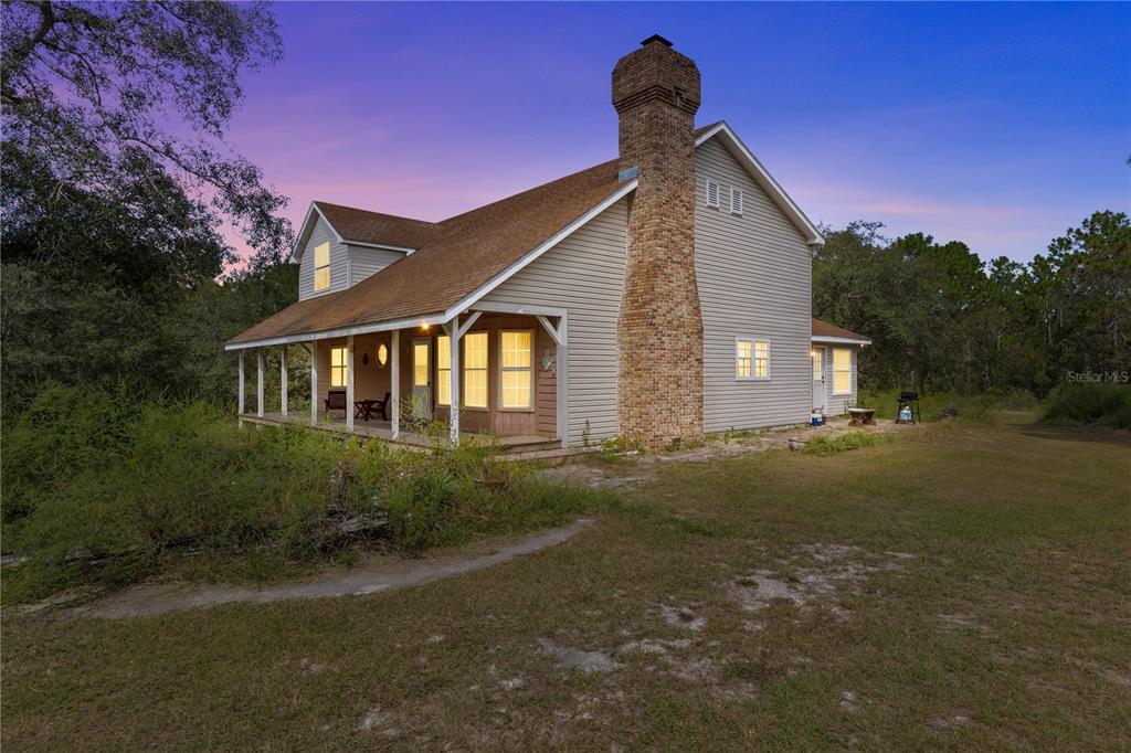 11419 Raschke Run Weeki Wachee, FL 34614 - Photo 16 of 19 a front view of a house with garden