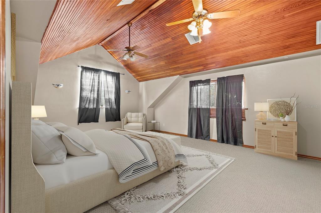 11419 Raschke Run Weeki Wachee, FL 34614 - Photo 8 of 19 a bedroom with a bed and a chandelier