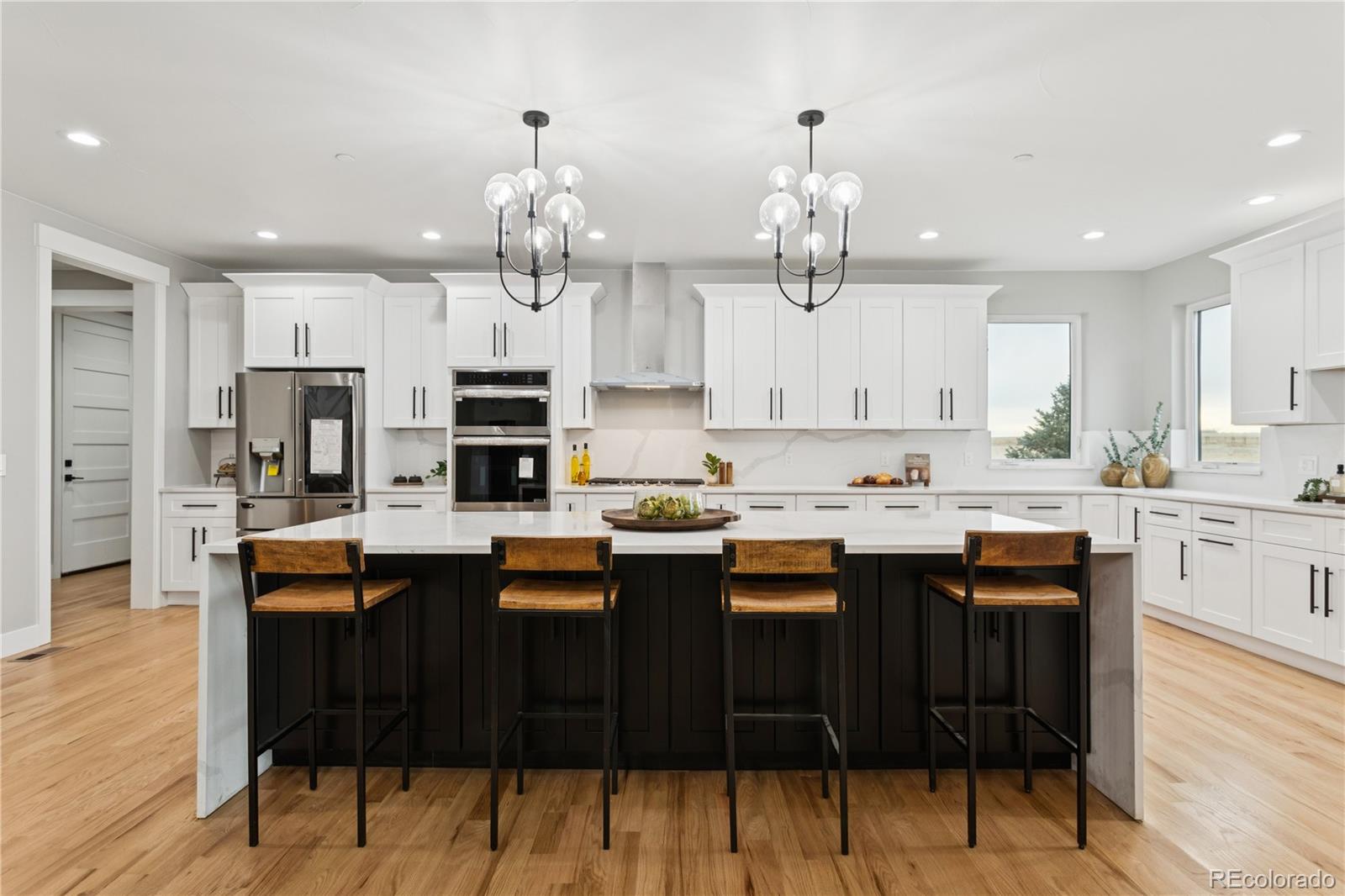 12550 Imboden Road Hudson, CO 80642 - Photo 13 of 50 a kitchen with granite countertop a sink cabinets and wooden floor