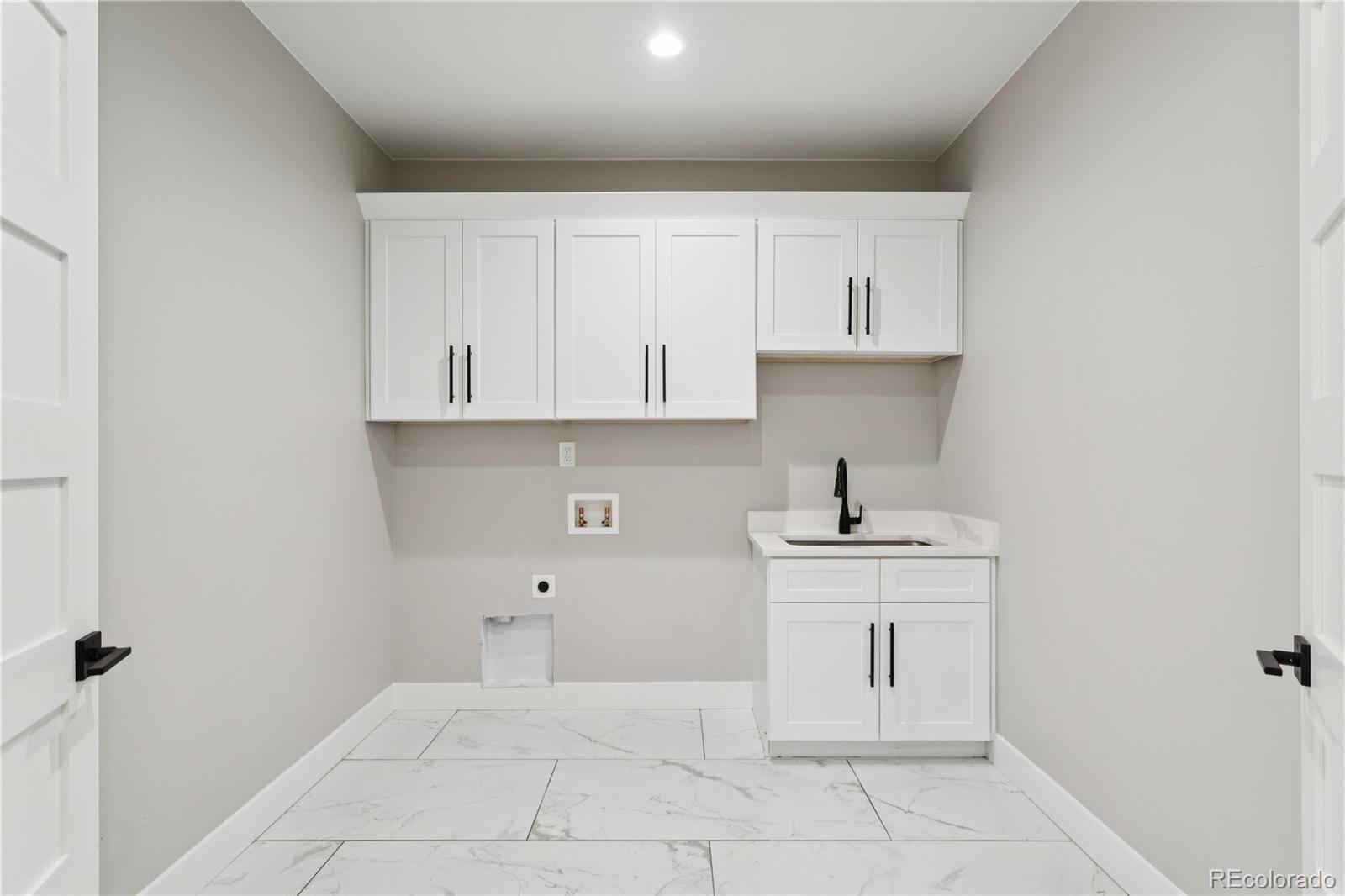 12550 Imboden Road Hudson, CO 80642 - Photo 17 of 50 a kitchen with white cabinets and a sink