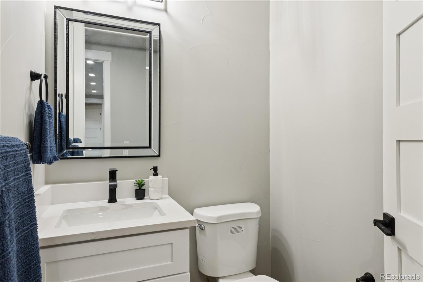 12550 Imboden Road Hudson, CO 80642 - Photo 26 of 50 a bathroom with a toilet sink and mirror