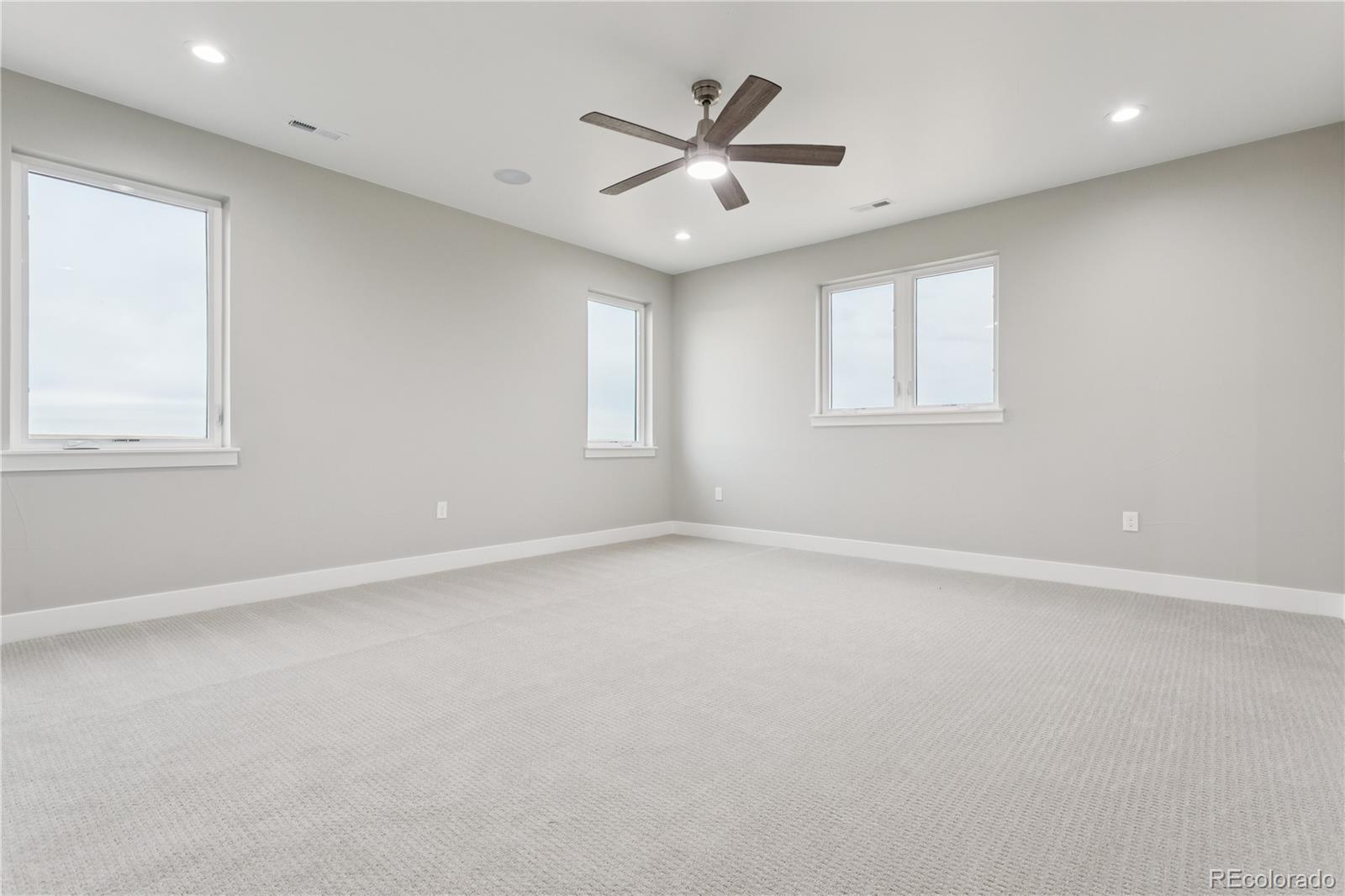 12550 Imboden Road Hudson, CO 80642 - Photo 29 of 50 an empty room with a window and a ceiling fan