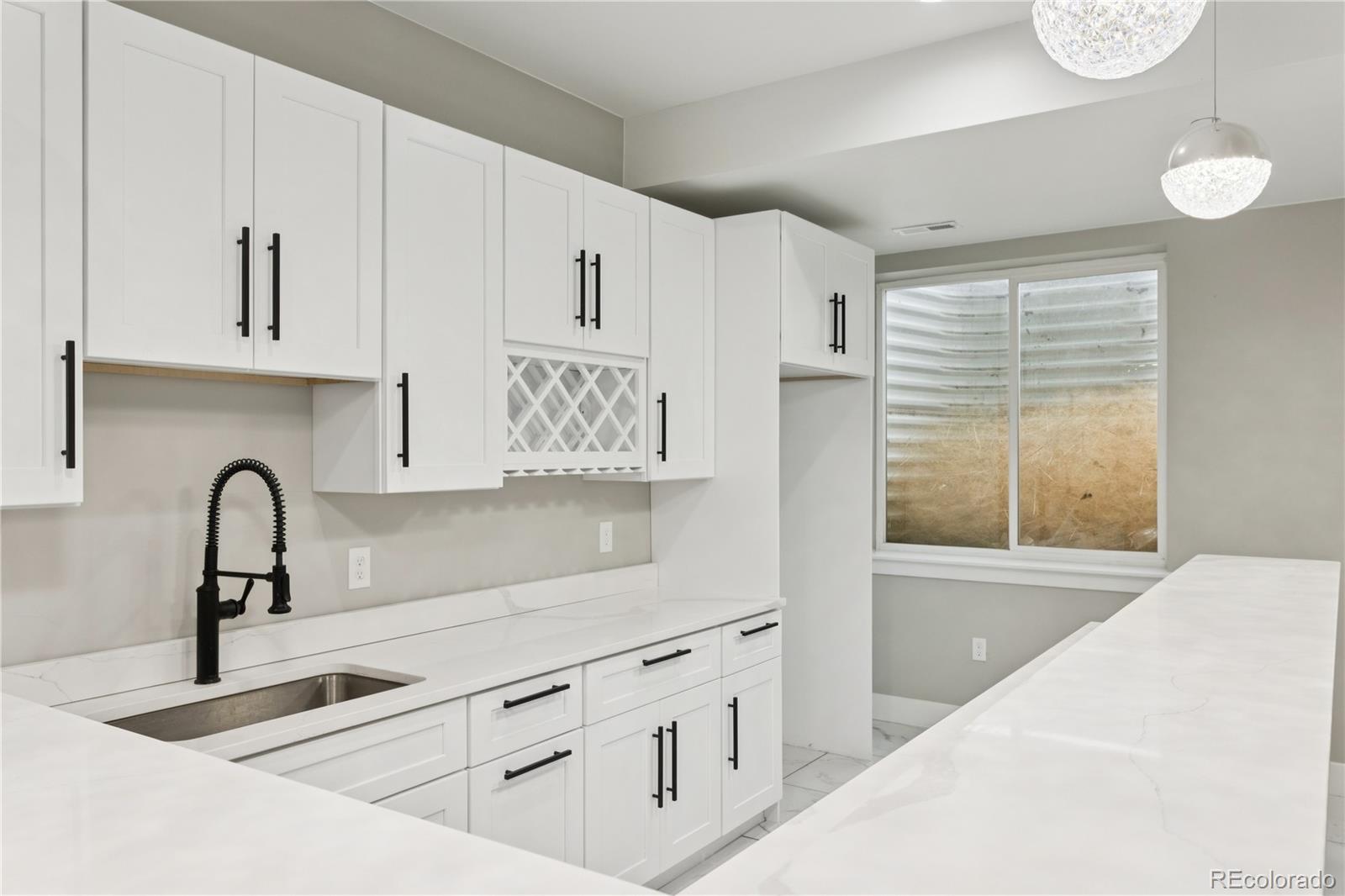 12550 Imboden Road Hudson, CO 80642 - Photo 34 of 50 a kitchen with stainless steel appliances a sink a stove and white cabinets