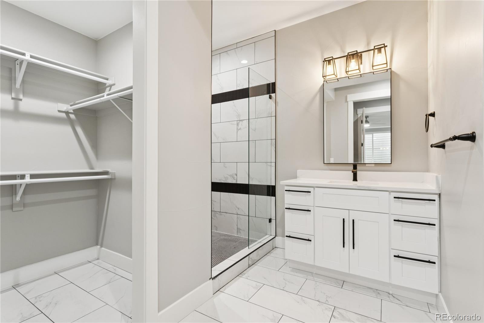 12550 Imboden Road Hudson, CO 80642 - Photo 35 of 50 a bathroom with a sink a vanity and mirror