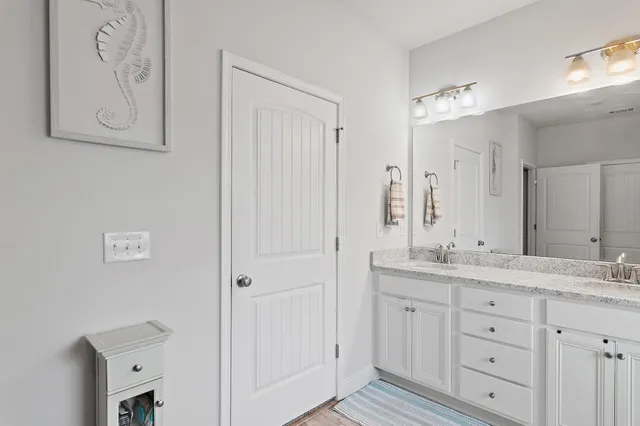 a bathroom with a tub shower vanity and a sink