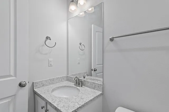 a white toilet sitting next to a bath tub