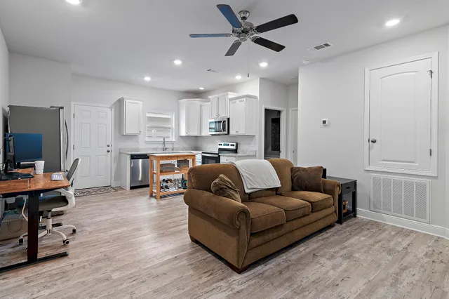 a living room with furniture and a chandelier