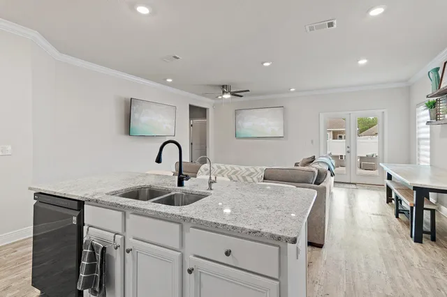 a view of living room with granite countertop furniture and a wooden floor