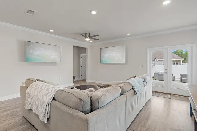 a living room with furniture and a chandelier