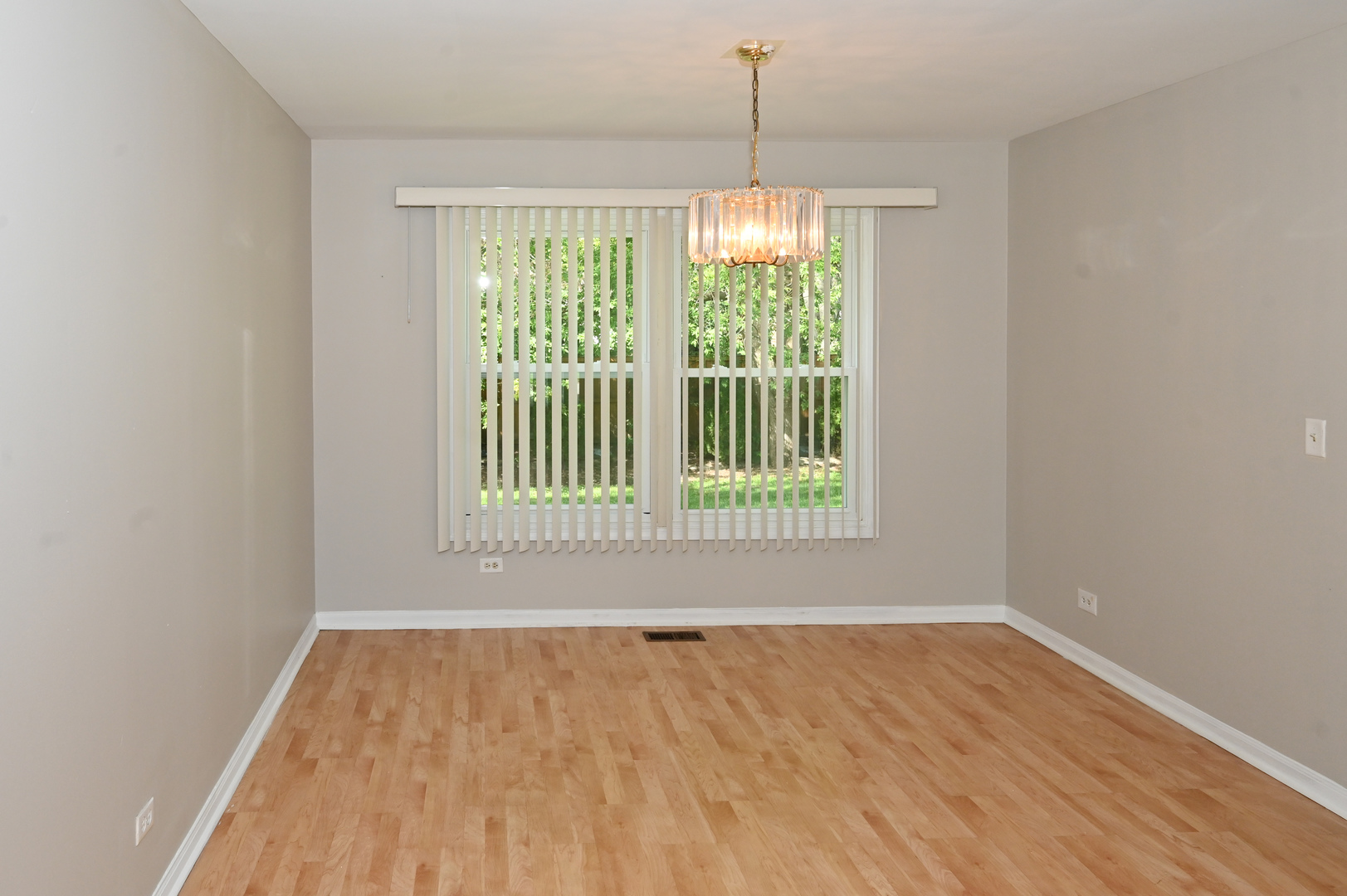 500 Greenview Lane Wheeling, IL 60090 - Photo 4 of 51 a view of an empty room with wooden floor and a window