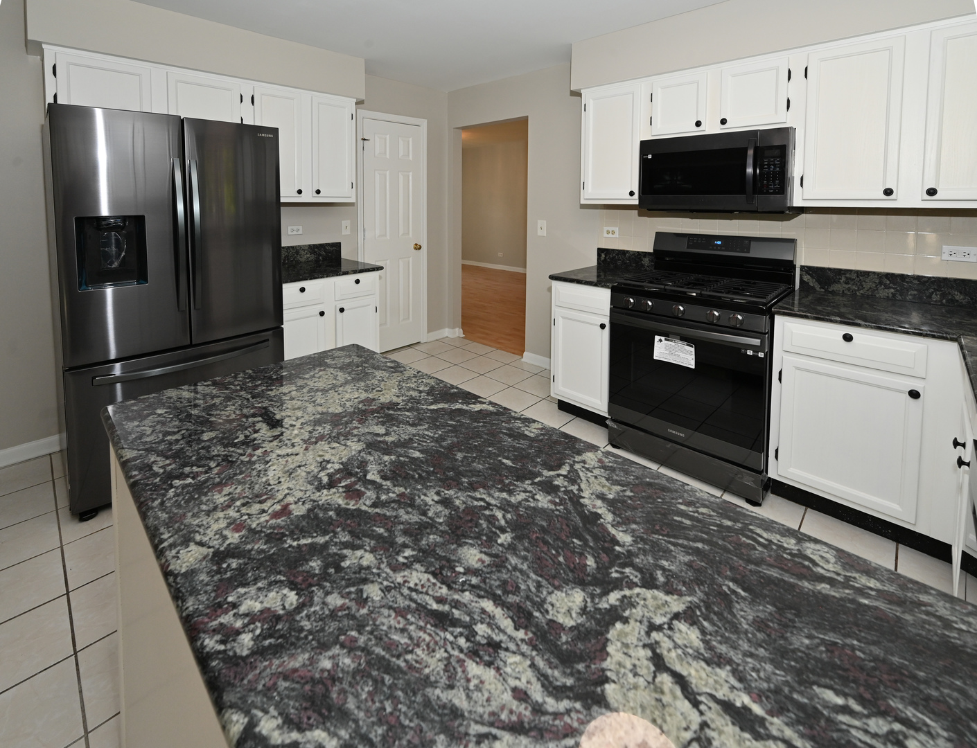 500 Greenview Lane Wheeling, IL 60090 - Photo 7 of 51 a kitchen with granite countertop a refrigerator and a stove top oven