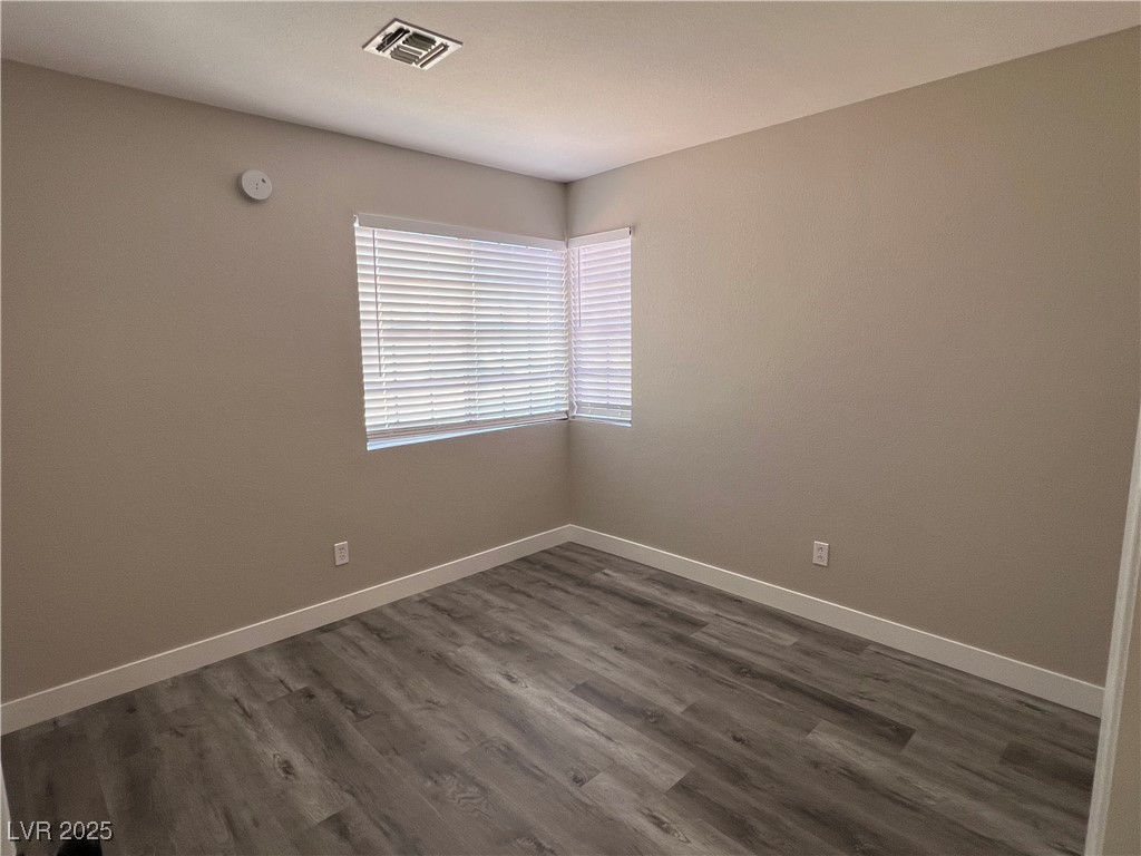 3238 Canyon Terrace Drive Laughlin, NV 89029 - Photo 22 of 41 Empty room with dark wood-type flooring and baseboards