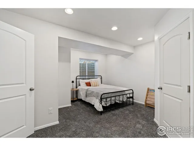 a spacious bedroom with a bed and a window