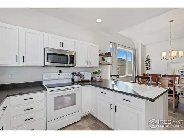 a kitchen with a sink stove and microwave