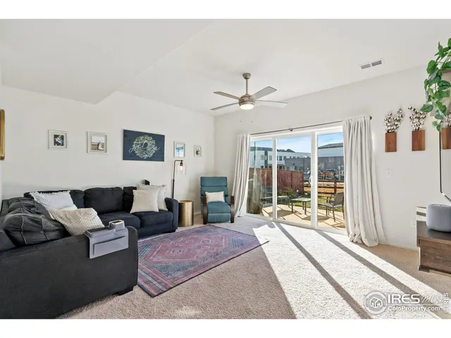 a living room with furniture and large windows