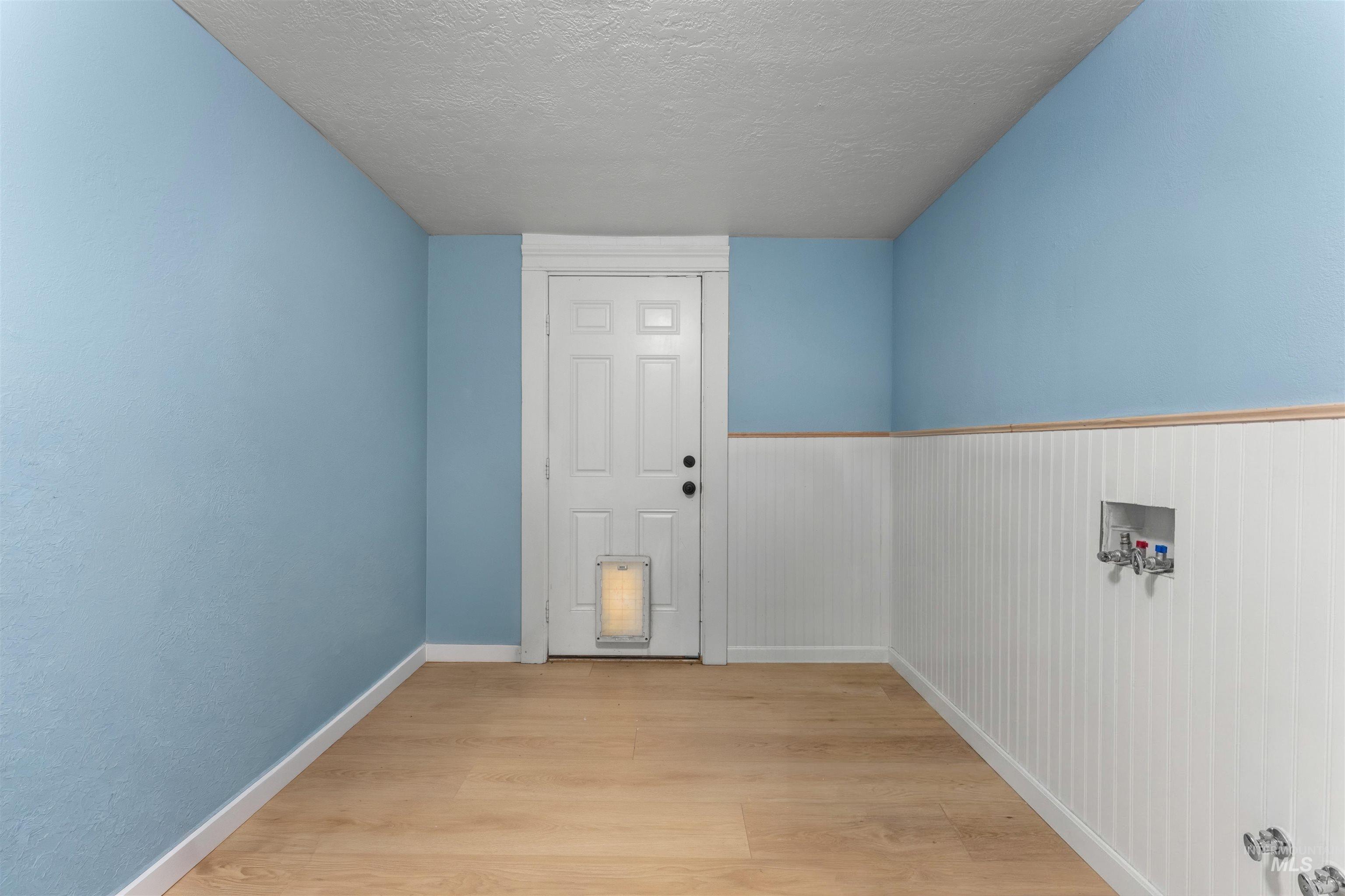 17441 Upper Pleasant Ridge Road Caldwell, ID 83607 - Photo 30 of 40 Light wood-finish flooring with white baseboards throughout
