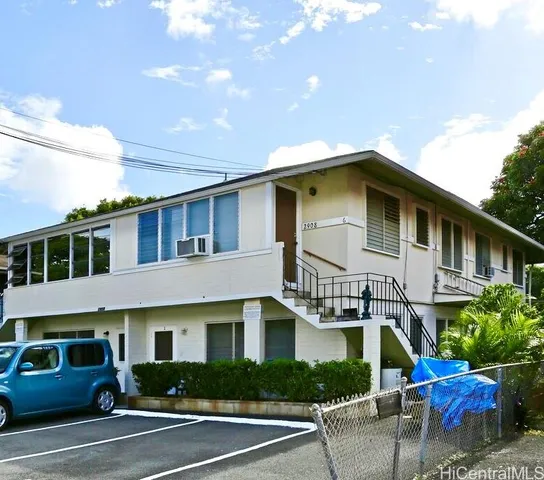 a front view of a house with plants and garage