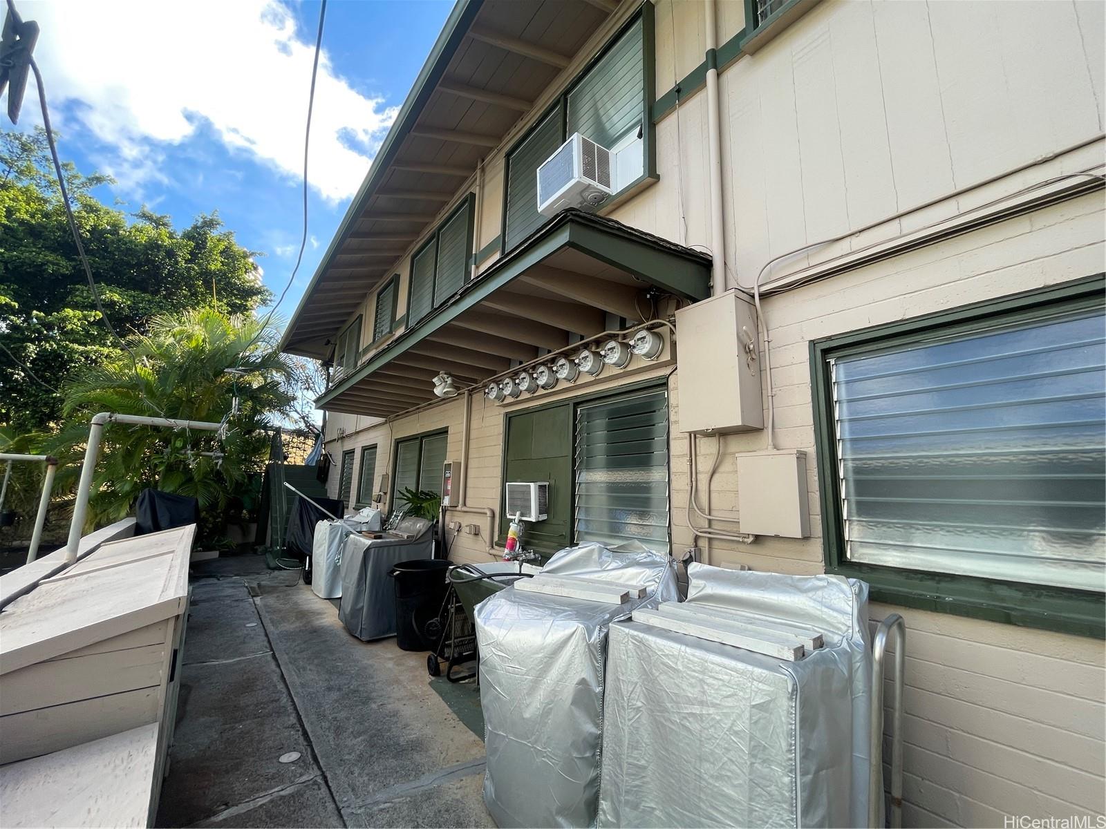 2908 Varsity Circle Honolulu, HI 96826 - Photo 7 of 11 a view of a patio with table and chairs a barbeque with wooden floor