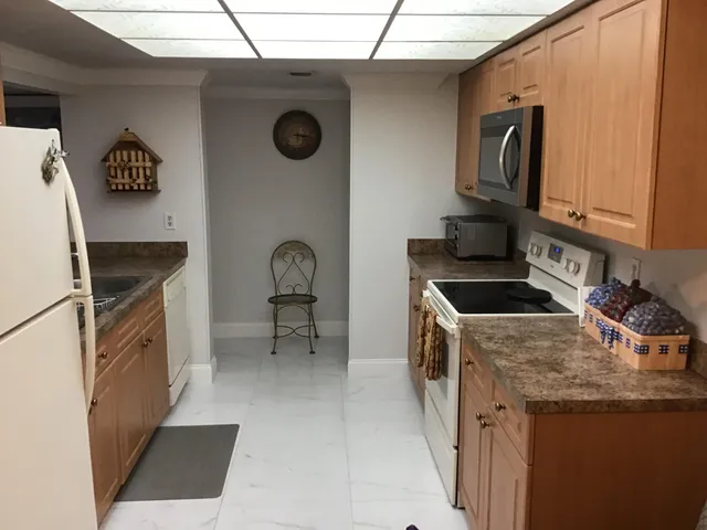 a kitchen with a stove a sink and a refrigerator