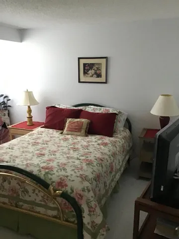 a bedroom with a bed and chair