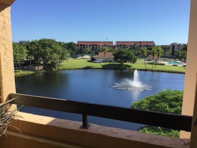 an aerial view of residential houses with outdoor space and seating