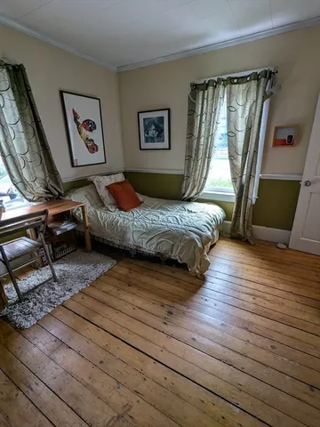 a bedroom with double bed and a window