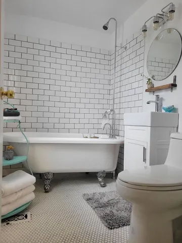 a bathroom with a toilet bathtub and shower