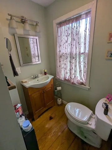 a bathroom with a sink mirror vanity and toilet