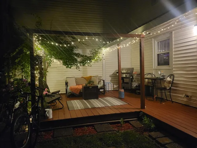 a view of a patio with wooden floor