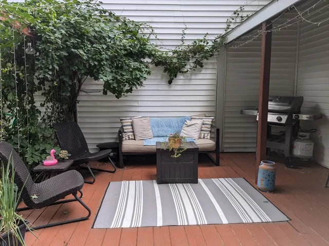 a view of a house with a yard and a wooden bench