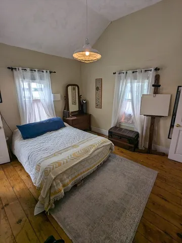 a bedroom with a bed and window