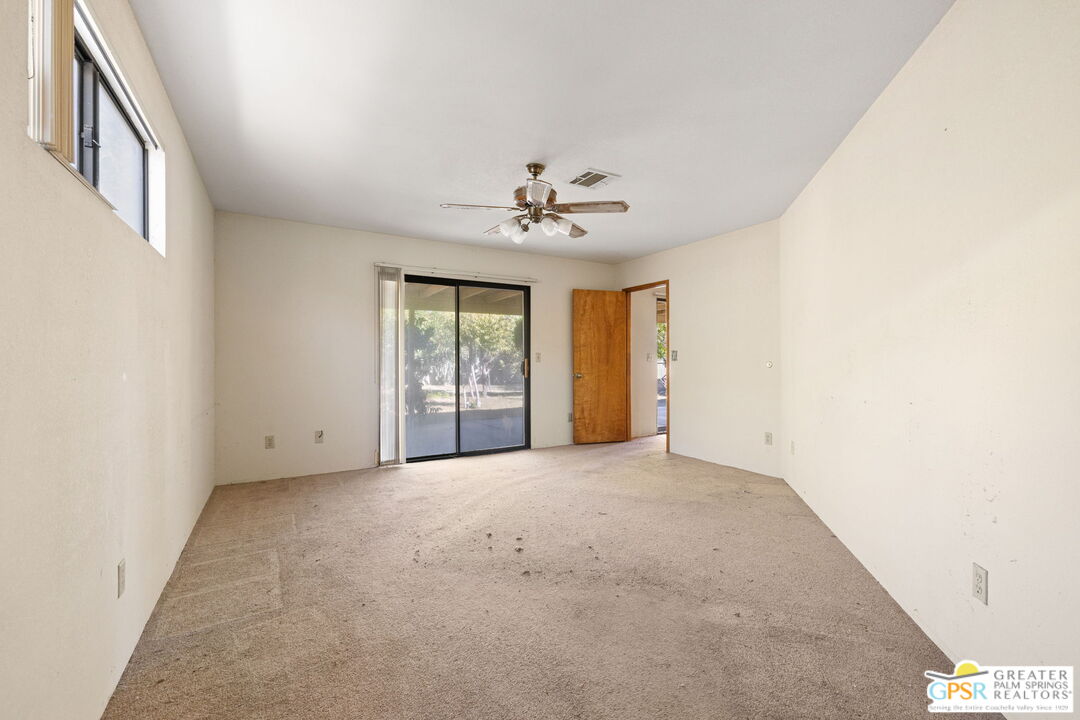 68600 Risueno Road Cathedral City, CA 92234 - Photo 21 of 30 an empty room with windows and ceiling fan