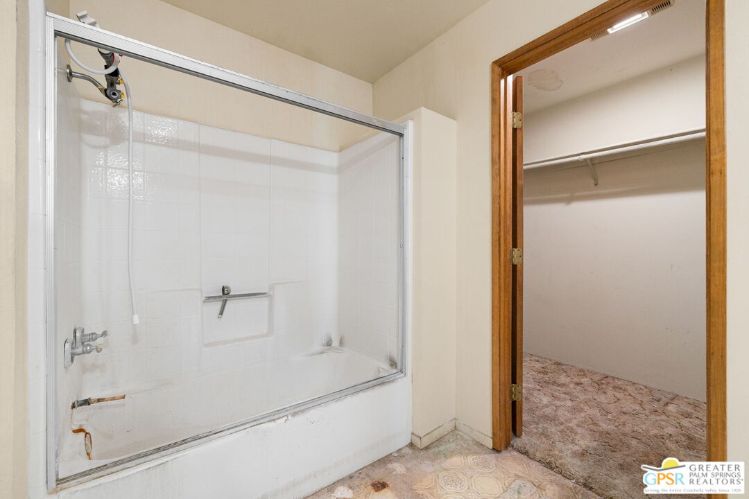 68600 Risueno Road Cathedral City, CA 92234 - Photo 24 of 30 a bathroom with a bathtub and a glass door shower