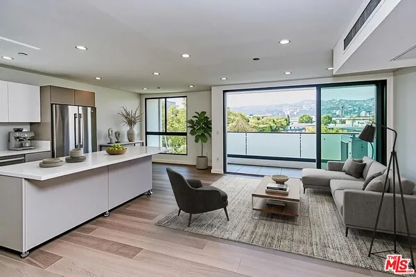 a living room with furniture and large windows