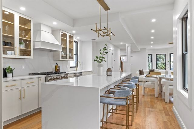 a living room with fireplace furniture and a wooden floor