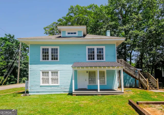 a front view of a house with a garden
