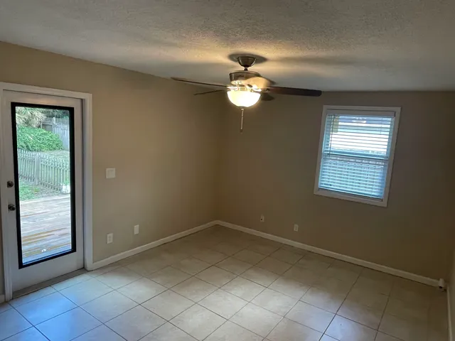 a view of an empty room with a ceiling fan