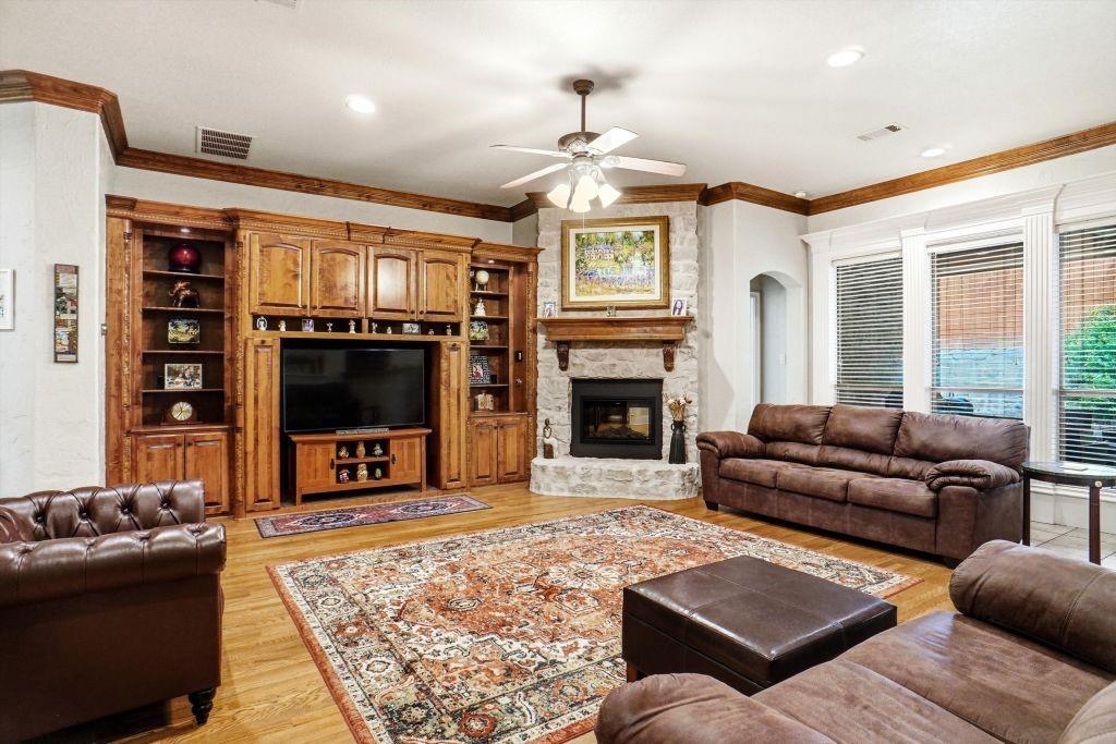 620 Highview Lane Hurst, TX 76054 - Photo 14 of 40 a living room with furniture a flat screen tv and a fireplace