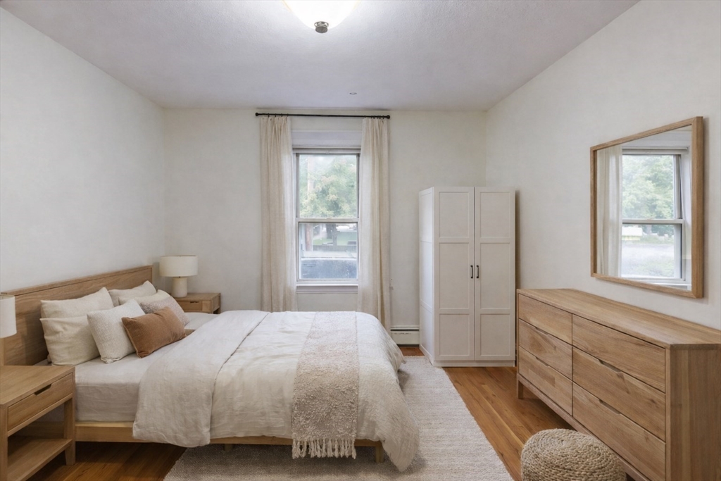 105 Walnut Street, Unit A Somerville, MA 02145 - Photo 6 of 14 a bedroom with a bed and a window