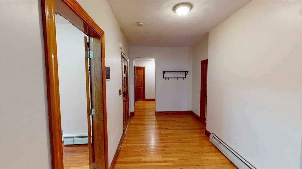 105 Walnut Street, Unit A Somerville, MA 02145 - Photo 8 of 14 a view of a hallway with wooden floor