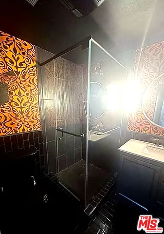 a bathroom with a mirror a toilet and a shower