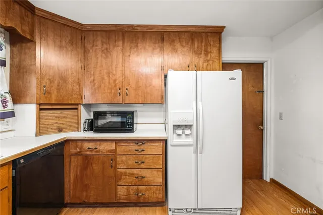 a kitchen with a refrigerator and a stove