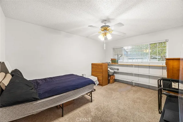 a bedroom with furniture and a window