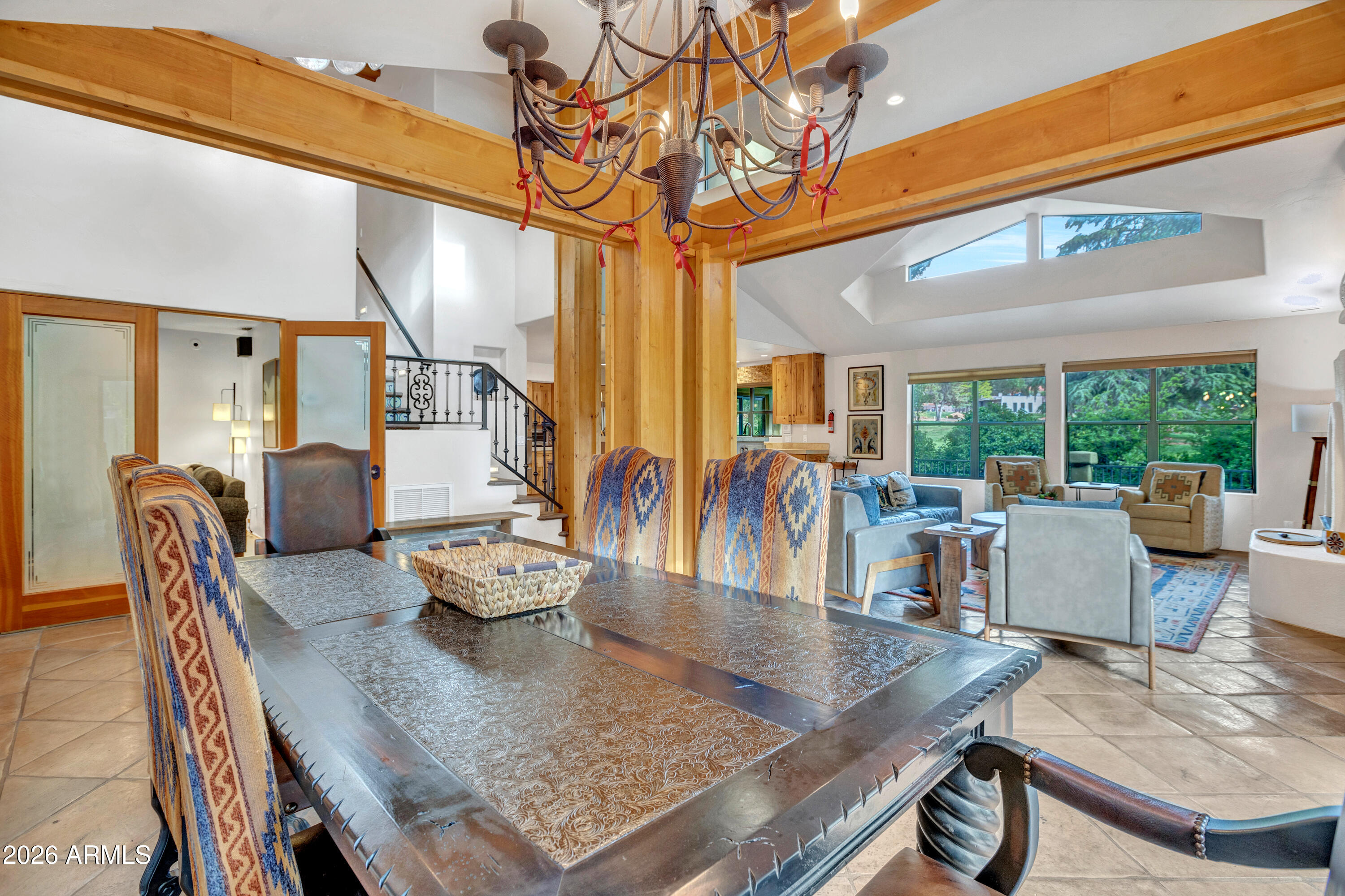 55 Ranch House Circle Sedona, AZ 86336 - Photo 12 of 61 a dining room with wooden floor a chandelier a wooden table and chairs