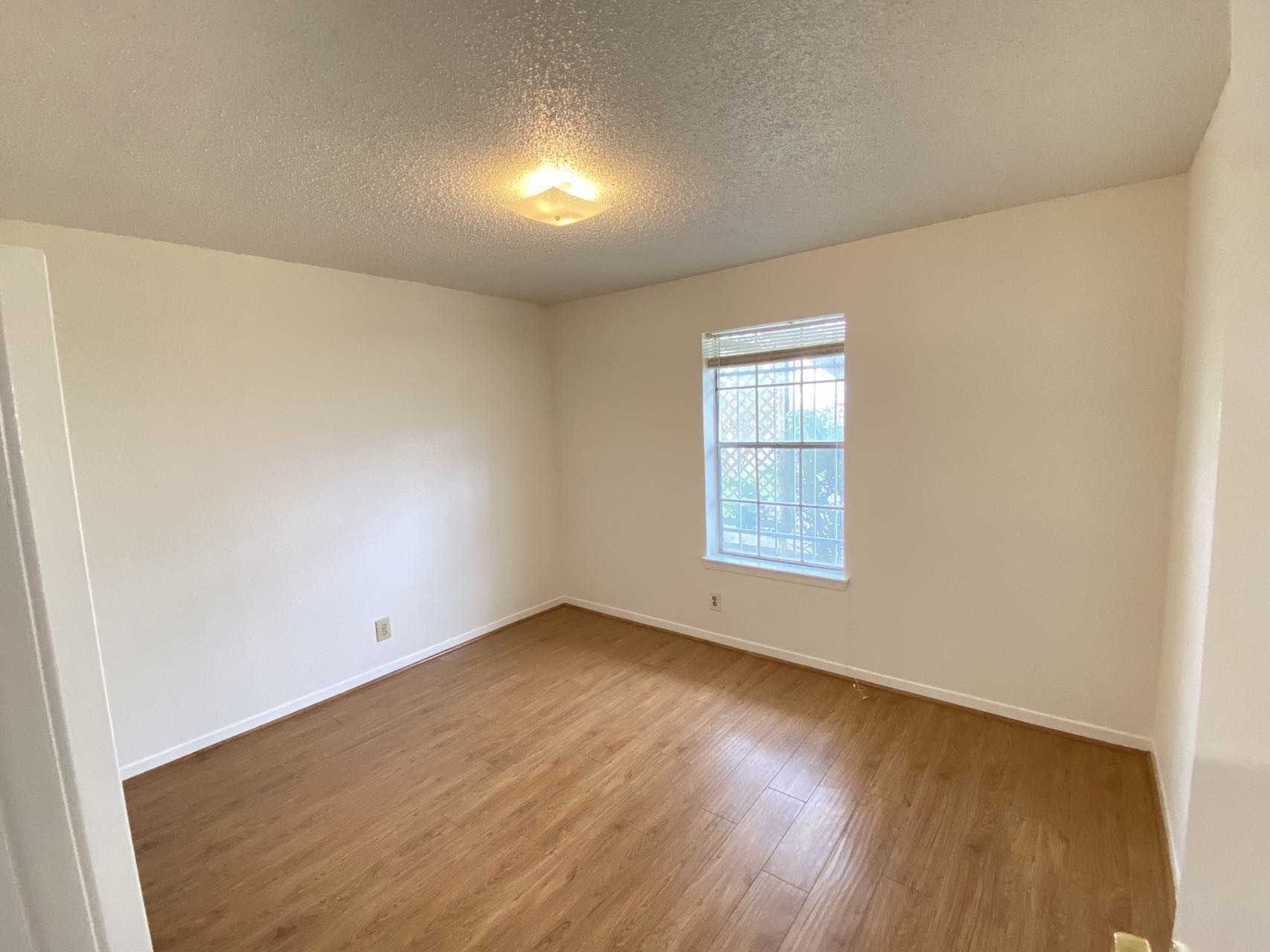 6201 Ranchester Drive, Unit 19 Houston, TX 77036 - Photo 15 of 26 an empty room with wooden floor and windows