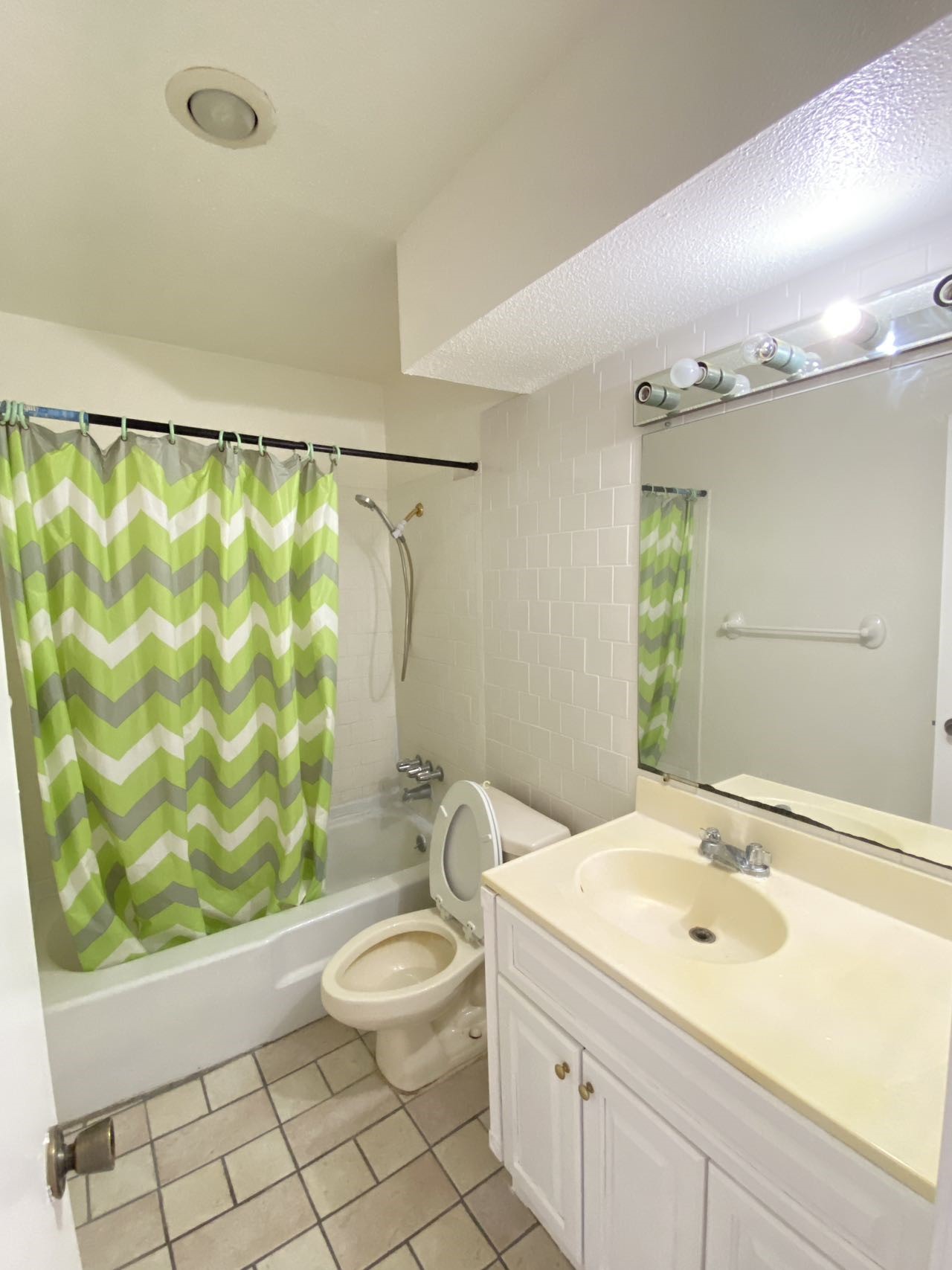 6201 Ranchester Drive, Unit 19 Houston, TX 77036 - Photo 24 of 26 a bathroom with a granite countertop sink a toilet a mirror and shower