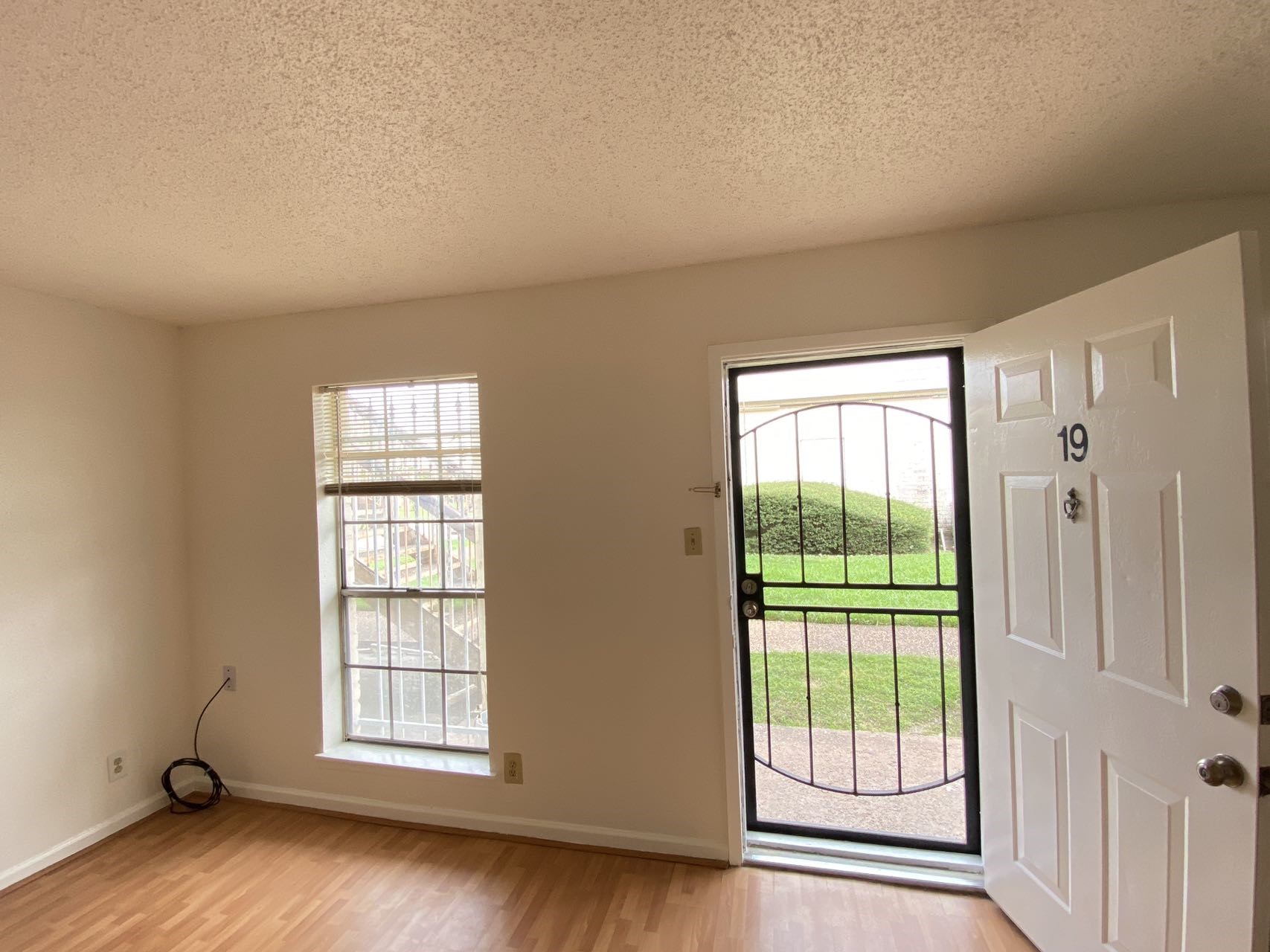 6201 Ranchester Drive, Unit 19 Houston, TX 77036 - Photo 5 of 26 an empty room with wooden floor and windows