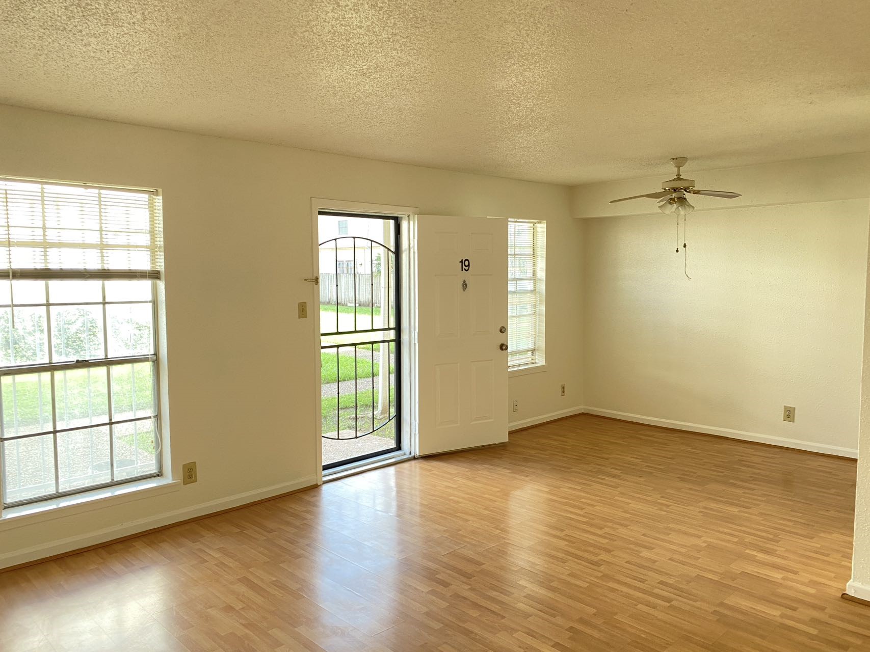 6201 Ranchester Drive, Unit 19 Houston, TX 77036 - Photo 6 of 26 an empty room with wooden floor and windows